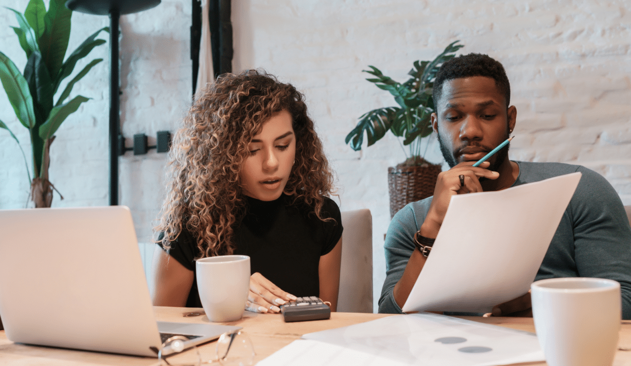 Couple at a desk reviewing home building options
