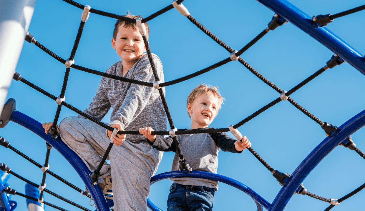 Kids playing in a TimberCraft community playground