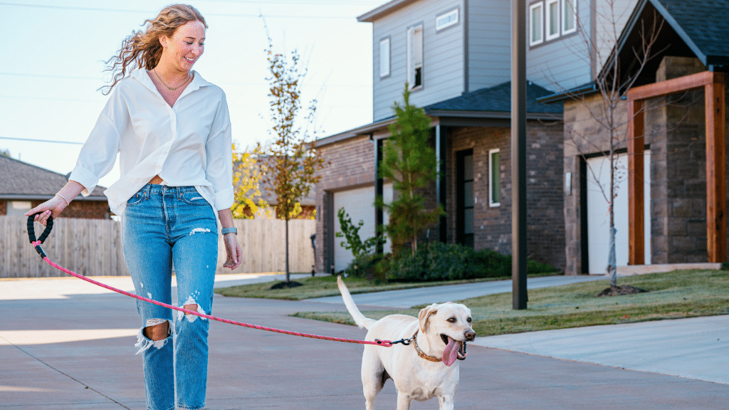 Woman walking her dog in Highland Pointe